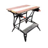 A Black & Decker workmate with vice tabletop on folding stand and angled legs.