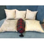A set of three linen embroidered cushions with signed square floral panels; a tartan bolster
