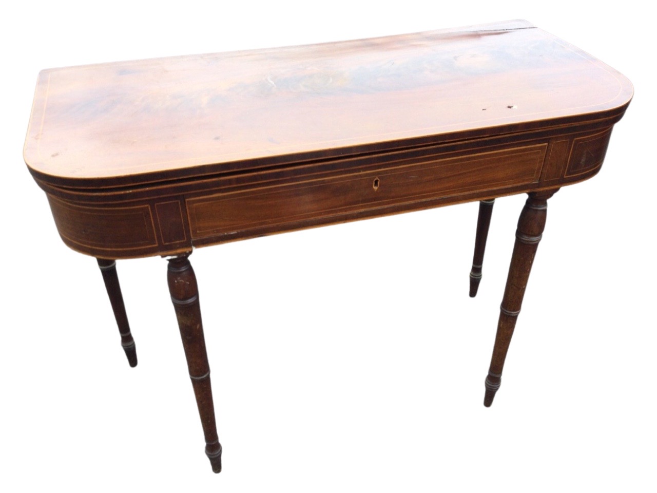 A nineteenth century mahogany turn-over-top tea table inlaid with boxwood stringing, the rounded