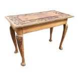 A nineteenth century carved oak table, the rectangular top with raised panel framed by carved