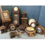 A collection of clocks requiring restoration including a carved cuckoo clock, mantle clocks, a