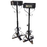 A pair of telescopic wrought iron flower arrangement holders with rectangular troughs on columns,