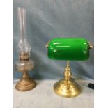 A Victorian oil lamp with faceted bun shaped glass reservoir on embossed brass base; and an