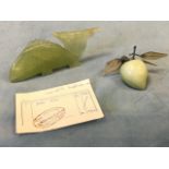 A carved jade fish, with 1960 foreign purchase receipt; and a polished jade fruit from a similar