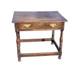 An eighteenth century oak side table with rectangular top above a long frieze drawer on baluster