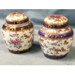 A pair of nineteenth century porcelain jars & covers decorated in the famile rose enamelled