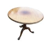 A circular early nineteenth century mahogany snap-top occasional table, the single piece moulded top