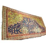 A Turkish asymmetrical rug with blue multi-floral field woven with long shaped medallion with