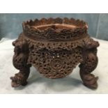 An oval carved Indian antique stool, lacking its upholstered seat, fthe pierced floral scalloped
