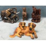 A carved soapstone elephant with calf; two black forrest type carved animals - a st bernard dog with