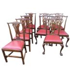 A set of four Chippendale style period mahogany dining chairs with scroll carved back rails above
