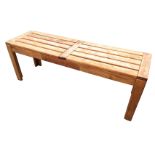 A hardwood bench with twin slatted top on rectangular corner legs. (47in)