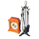 A contemporary wrought iron fireside companion set with shovel, tongs, brush and poker on stand; and