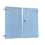 A pair of large garage doors of boarded tongue & groove Z-frame construction, mounted with iron