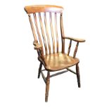 A Victorian elm farmhouse armchair with slatback above shaped arms on ring-turned spindles, the