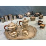 An art nouveau four-piece pewter teaset on tray by Hampden with stylised hammered decoration;