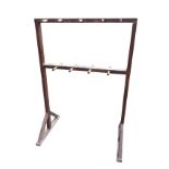 A tall 5ft stained pine coatstand, with nine dowel pegs either side of the rectangular frame, with