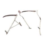 An antique scythe with chamfered ash shaft; another similar with turned handles; and an old ditching