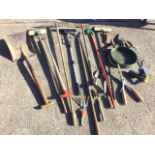 Miscellaneous garden tools - brushes, rakes, a shovel, hoes, hand tools, trowels, snippers, etc. (