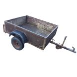 A rectangular box trailer on angle-iron frame with rear drop-side, the single axel on pneumatic