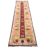 A Turkish runner woven with long rectangular maroon panel of crossed arrowheads framed by waved band