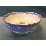 A nineteenth century Japanese porcelain bowl decorated with frieze of alternating scrolled and