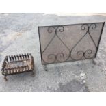 A rectangular fire grate of basket form with scroll cast sides framing grill, raised on four