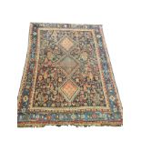 An antique Bokhara rug woven with three serrated lozenges on busy ink blue field with paisley