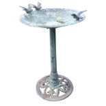 A metal garden birdbath, the circular leaf moulded bowl with birds on rim, supported on an hexagonal