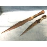 A North African dagger with shaped tapering steel blade having waisted hardwood handle mounted