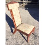 A Victorian mahogany nursing chair, the high back carved with pierced scrolled crest and fleur-de-