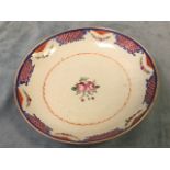 A Chinese style stoneware bowl decorated with central flower motif framed by waved border, the rim