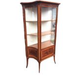 An Edwardian mahogany vitrine by Maple & Co, the satinwood crossbanded cabinet with concave glass
