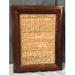 A nineteenth century sampler dated 1819, sewn by a Mary Wagstaff, the alphabet with waved floral