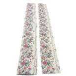 A pair of lined floral curtains printed with bands of springtime flowers on fawn ground. (81.5in) (