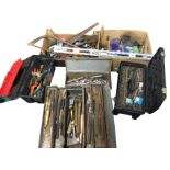 A large quantity of hand tools - socket sets, metal tool boxes, hammers, chisels, files,