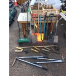 A quantity of garden tools including spades, a snow shovel, a Qualcast fertiliser spreader, lawn