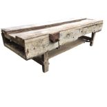 A large 10ft rectangular workbench with channeled top and deep aprons raised on rectangular legs