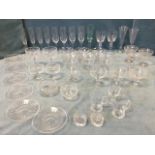 A collection of glasses including sundae dishes, flutes, a set of six dessert bowls, a pair of