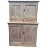 A Victorian pitch pine cupboard, the top with moulded cornice above panelled doors enclosing a