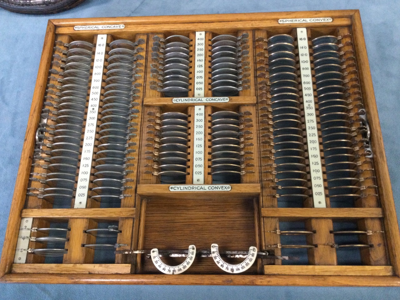 A cased optometrist set of glasses, the numbered lenses in fitted oak tray, the case with brass - Image 2 of 3