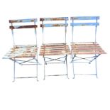 A set of three folding metal garden chairs with slatted backs & seats on rectangular legs with pad