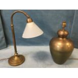 A brushed brass desk lamp, the opaque glass shade on arched arm, supported on a fluted column with
