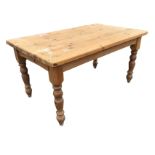 A 5ft pine kitchen table with thick rectangular top above moulded aprons, raised on turned legs. (