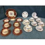 An Aynsley teaset decorated with polychrome floral medallions on cream ground framed by maroon