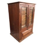 A Victorian mahogany coin collectors cabinet with moulded top above glazed doors enclosing 36 fitted