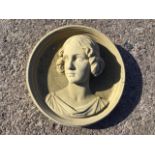 A circular composition stone medallion cast with bust of a renaissance style lady in moulded