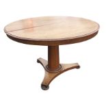 A Victorian mahogany breakfast table, the circular moulded top supported and folding on a tapering
