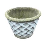 A large composition stone tapering garden pot with ropetwist rim and interwoven lattice body. (