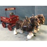 A model Buchanan Whisky dray wagon with a pair of ceramic carthorses, the painted four-wheel cart